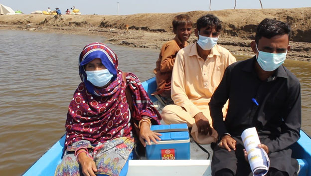  Lady Health Worker Amina travelling by boat to reach children with polio drops