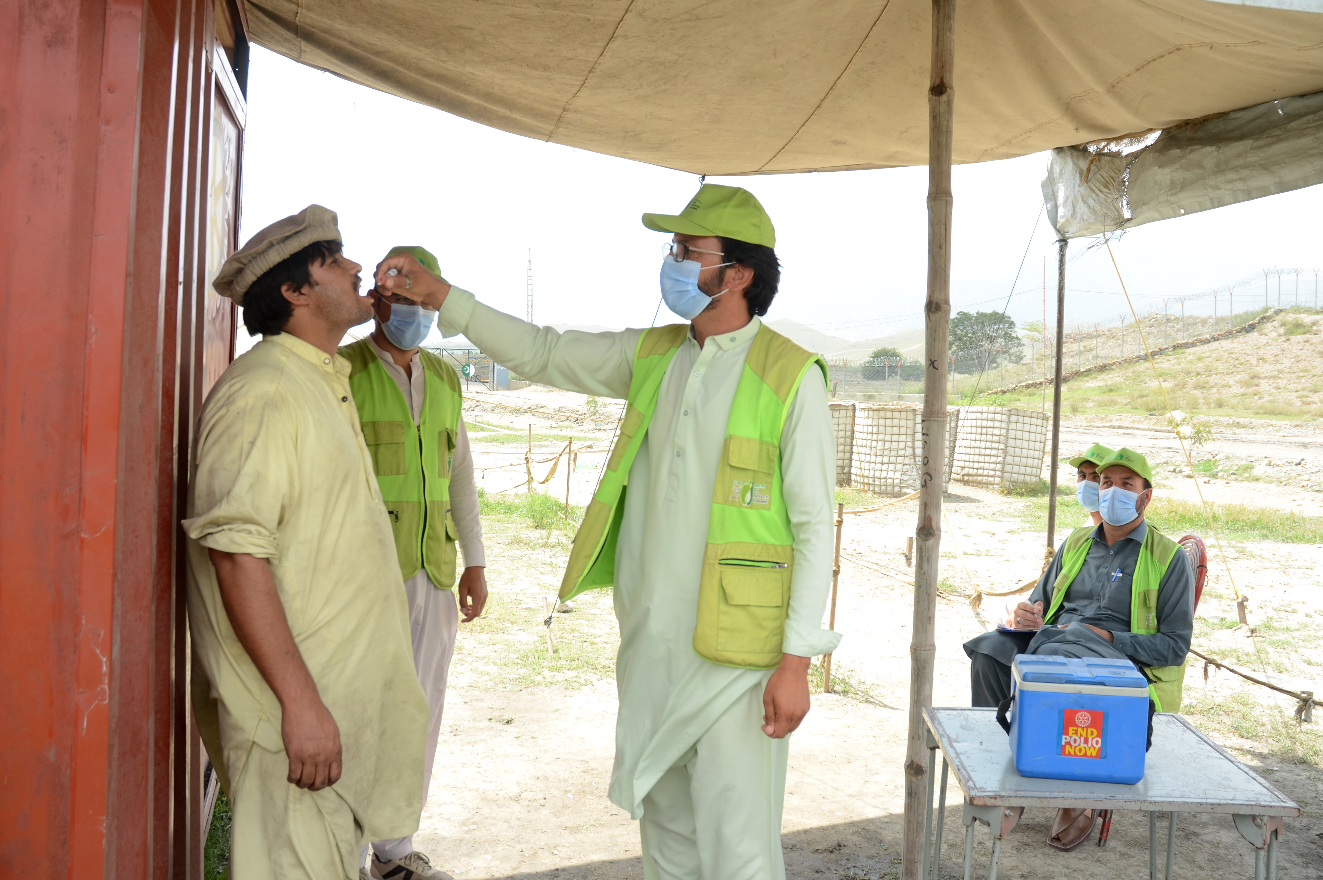 Polio worker, is administrating polio drop