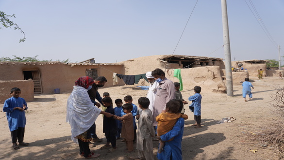 Social mobilisers bring children to a makeshift vaccination post in Dera Ghazi Khan, Punjab.